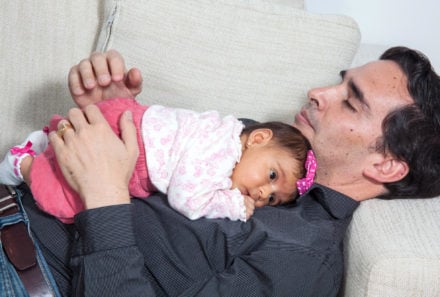 baby sleeping on fathers chest